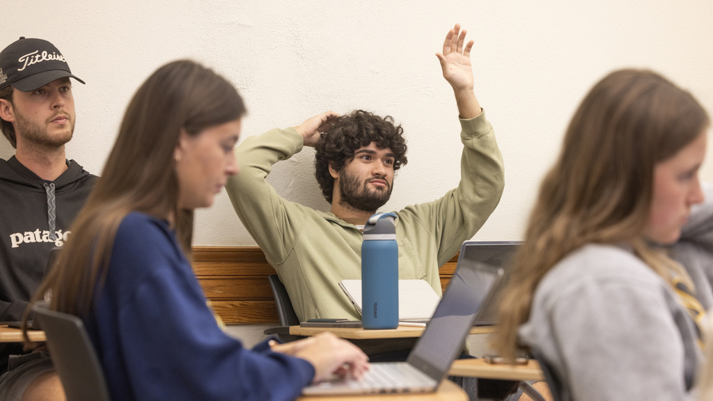 Student raises his hand in a History of Oil class taught by Ty Priest